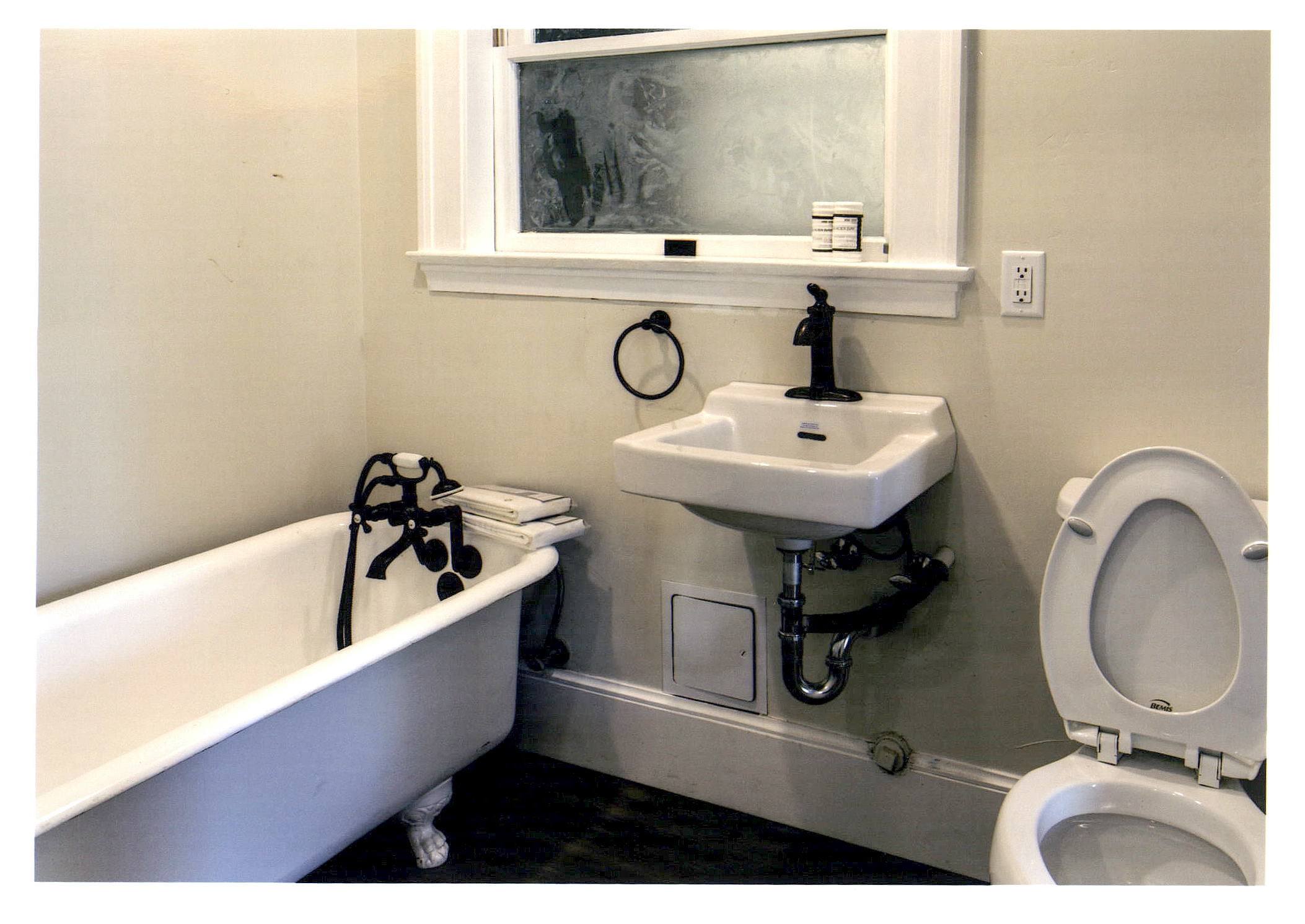 After: new bathroom and fixtures with restored light well window.